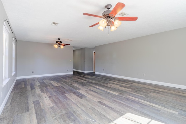 unfurnished room with ceiling fan and dark hardwood / wood-style flooring