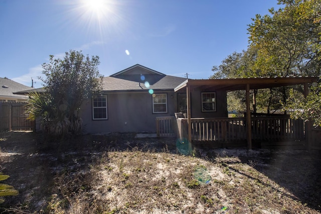 back of property with a carport