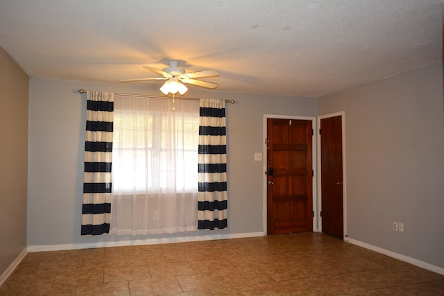 spare room featuring ceiling fan and a textured ceiling