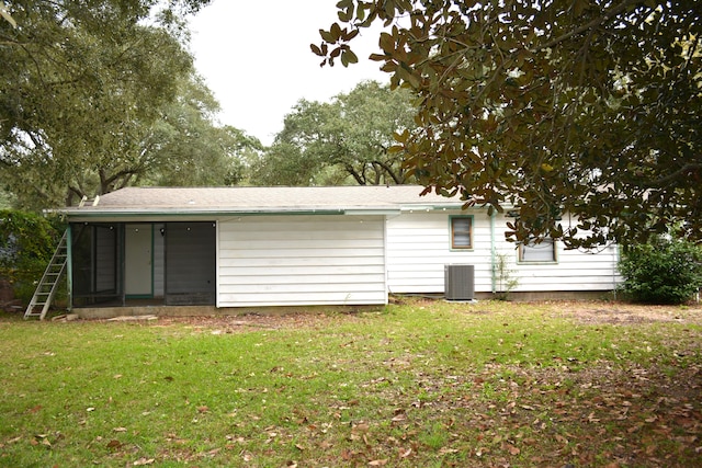 back of house featuring a yard and cooling unit