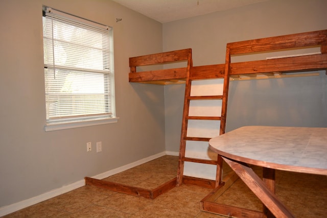 unfurnished bedroom featuring light tile patterned flooring