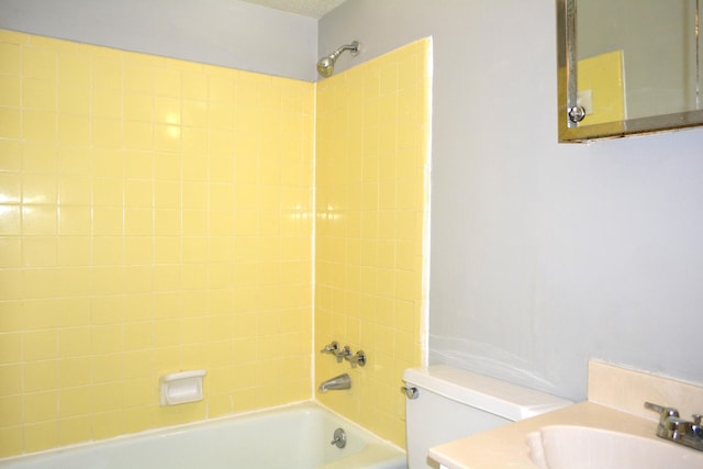 full bathroom with vanity, tiled shower / bath combo, and toilet