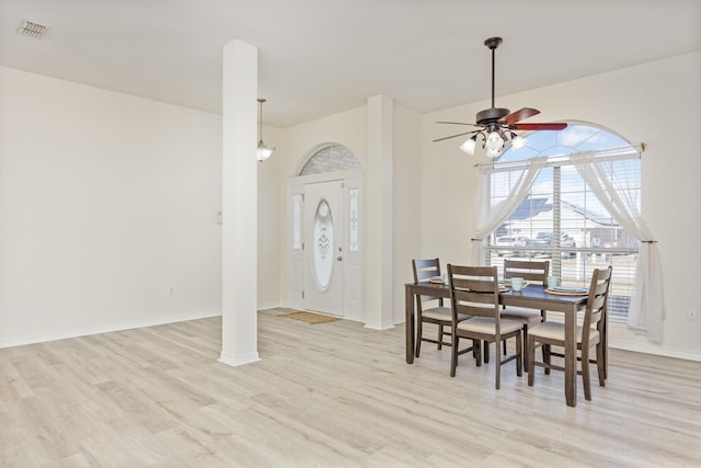 dining area with light wood-type flooring and ceiling fan