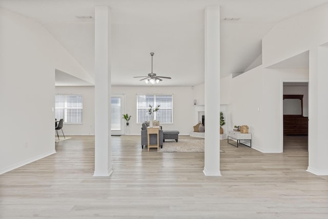 unfurnished living room with light hardwood / wood-style floors, plenty of natural light, and ceiling fan