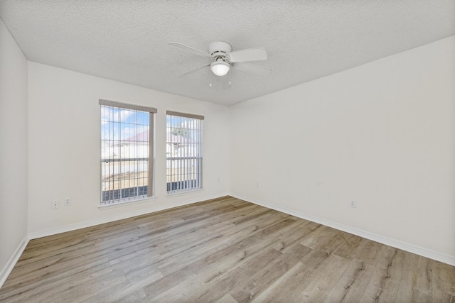 unfurnished room with a textured ceiling, light hardwood / wood-style flooring, and ceiling fan