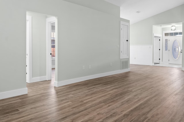 interior space featuring hardwood / wood-style flooring and vaulted ceiling