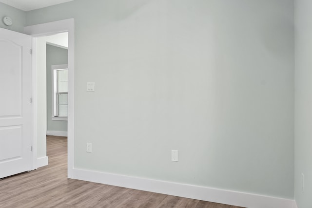 unfurnished room with light wood-type flooring