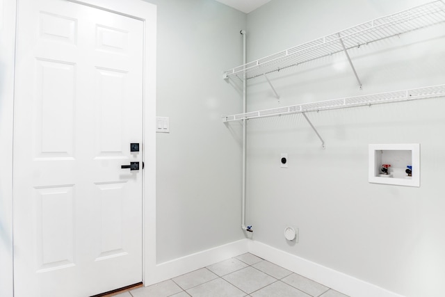 clothes washing area featuring hookup for a washing machine, hookup for a gas dryer, electric dryer hookup, and light tile patterned flooring