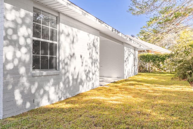 view of side of home featuring a lawn