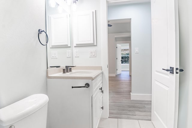 bathroom with hardwood / wood-style floors, vanity, and toilet