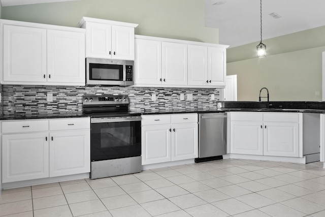 59 Marigot Bay Cir, Miramar Beach, FL 32550 - kitchen featuring stainless steel appliances, backsplash, a sink, high vaulted ceiling, and white cabinetry
