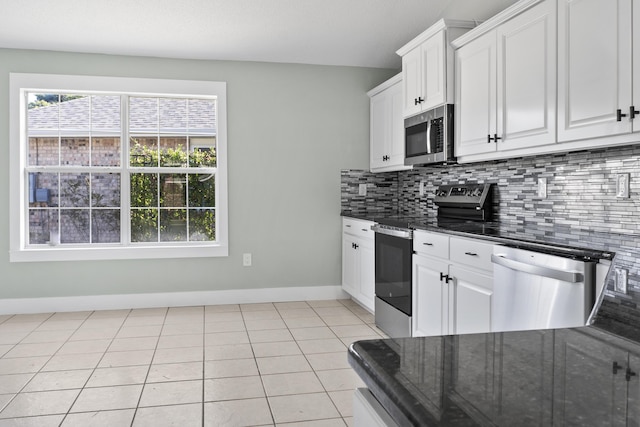 59 Marigot Bay Cir, Miramar Beach, FL 32550 - kitchen with appliances with stainless steel finishes, baseboards, backsplash, white cabinetry, and dark stone countertops