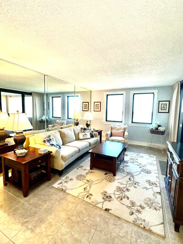 tiled living room featuring a textured ceiling and a healthy amount of sunlight