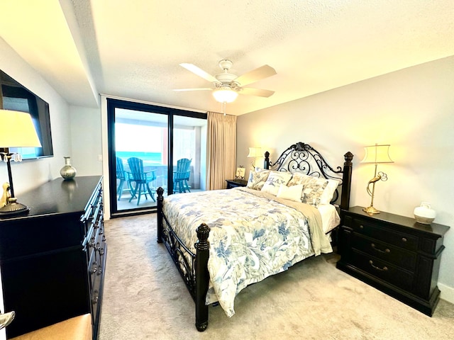 carpeted bedroom with a textured ceiling, access to outside, and ceiling fan