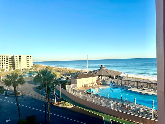 exterior space featuring a water view and a beach view