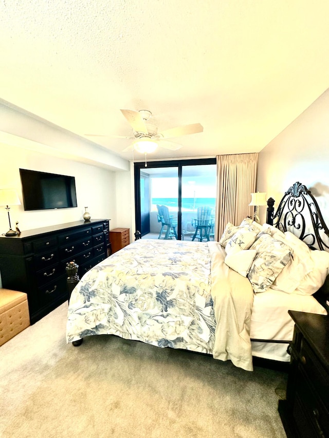 carpeted bedroom featuring access to outside and ceiling fan