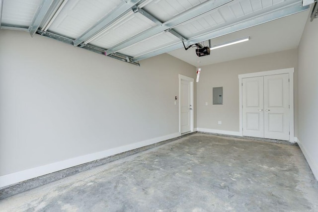 garage with electric panel and a garage door opener