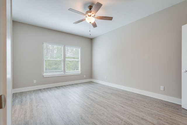 spare room featuring ceiling fan and light hardwood / wood-style flooring