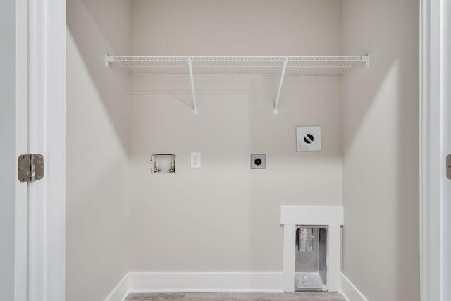 laundry area featuring electric dryer hookup, hookup for a washing machine, and hardwood / wood-style flooring