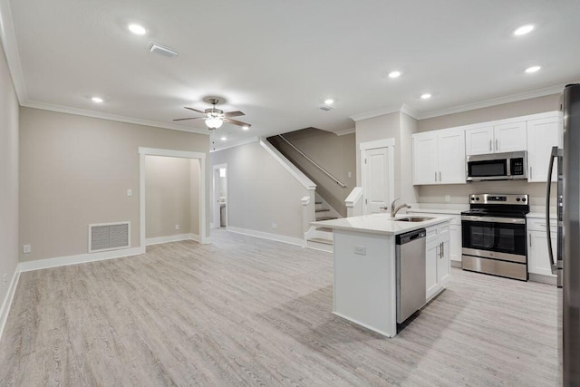 kitchen with white cabinetry, sink, appliances with stainless steel finishes, and light hardwood / wood-style flooring