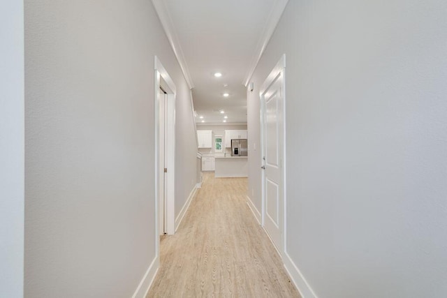 hall featuring light hardwood / wood-style floors and ornamental molding