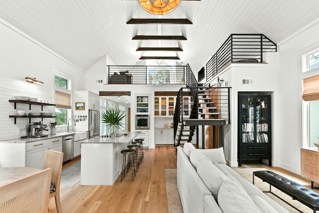 living room with high vaulted ceiling, wood ceiling, and light wood-type flooring