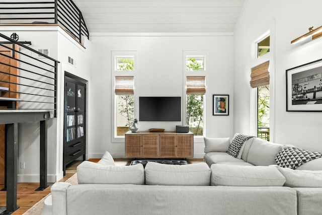 living room with wood-type flooring, high vaulted ceiling, and wooden ceiling