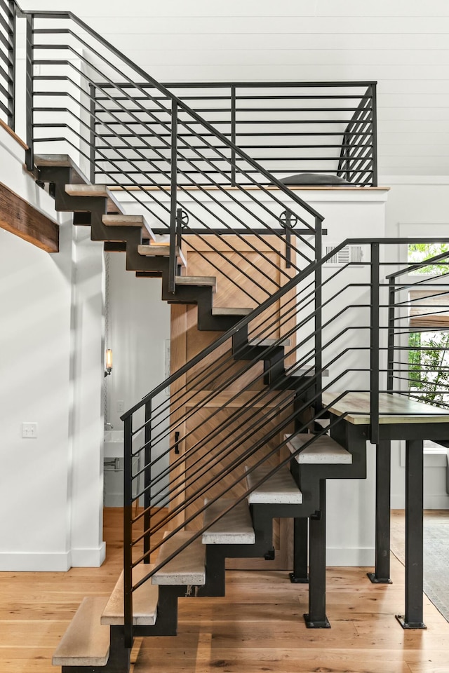 stairs featuring hardwood / wood-style floors