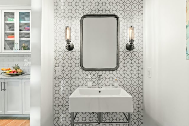 bathroom featuring decorative backsplash and hardwood / wood-style flooring