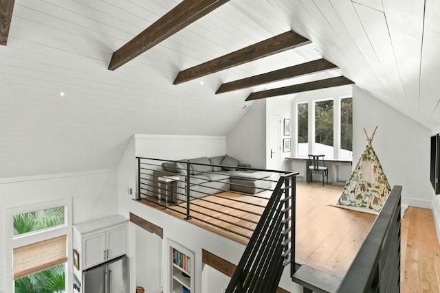 stairway featuring lofted ceiling with beams, hardwood / wood-style flooring, and wooden ceiling