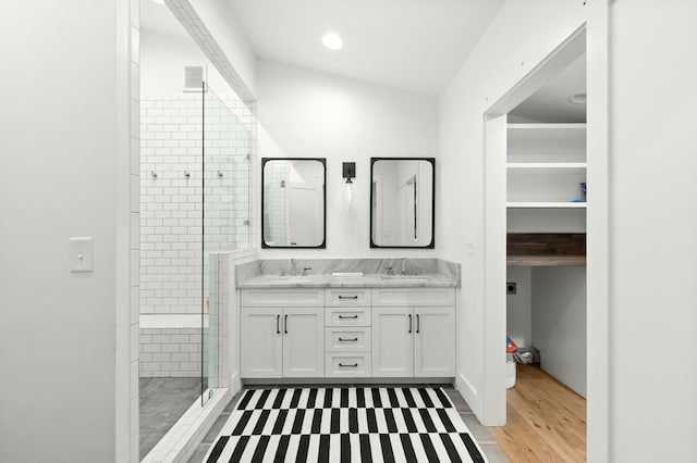 bathroom with hardwood / wood-style flooring, vanity, an enclosed shower, and vaulted ceiling