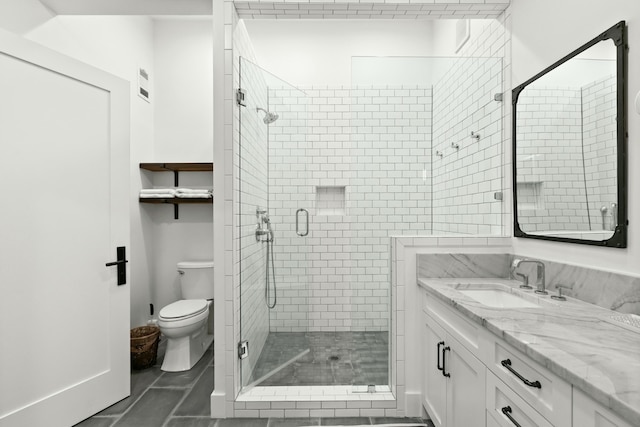 bathroom with tile patterned floors, vanity, an enclosed shower, and toilet