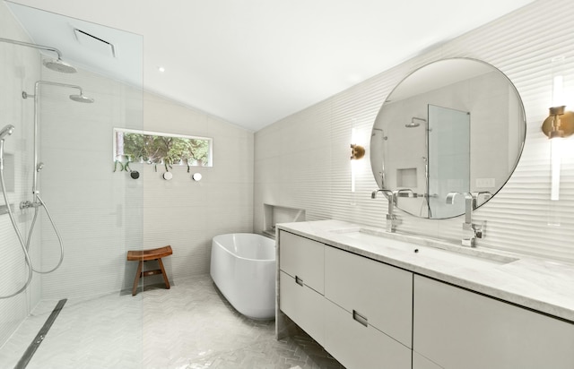 bathroom featuring vanity, separate shower and tub, and vaulted ceiling