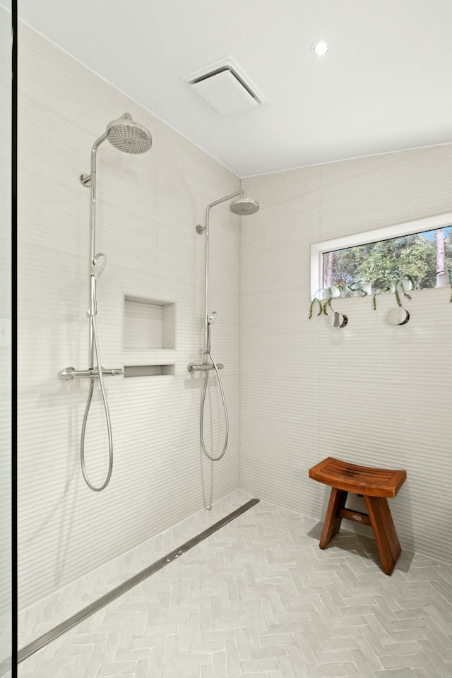 bathroom with a tile shower