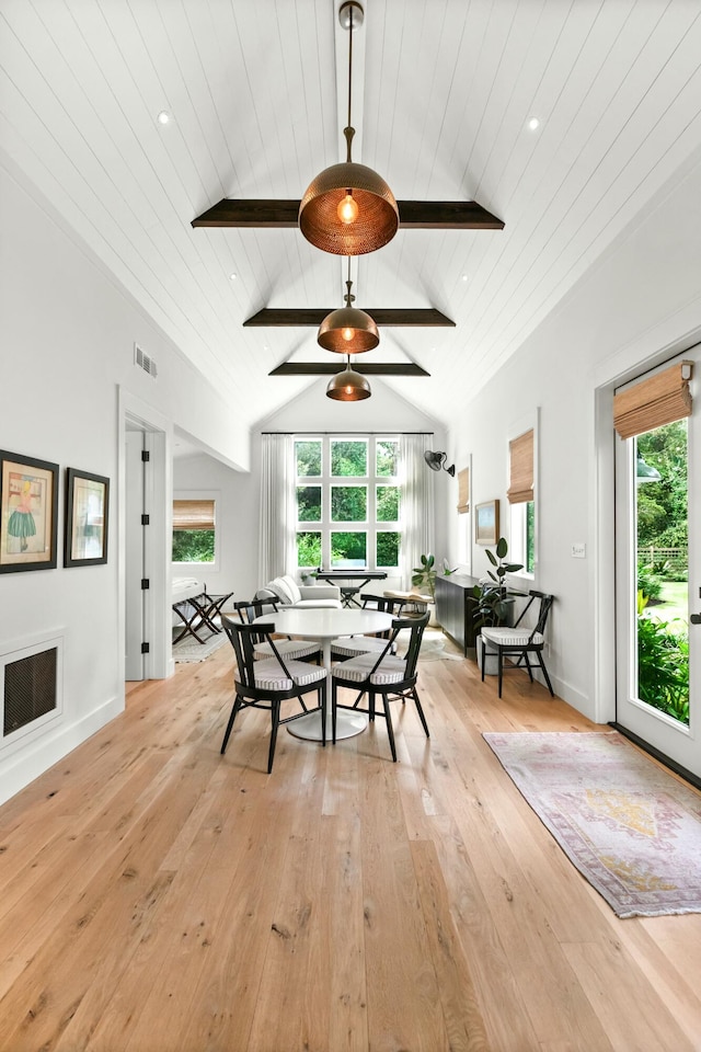 dining room featuring vaulted ceiling with beams, light hardwood / wood-style flooring, and wooden ceiling