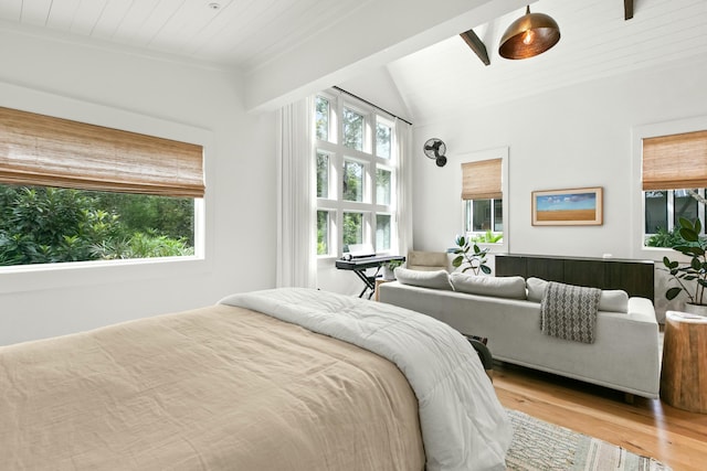 bedroom featuring vaulted ceiling with beams, light hardwood / wood-style floors, and wooden ceiling