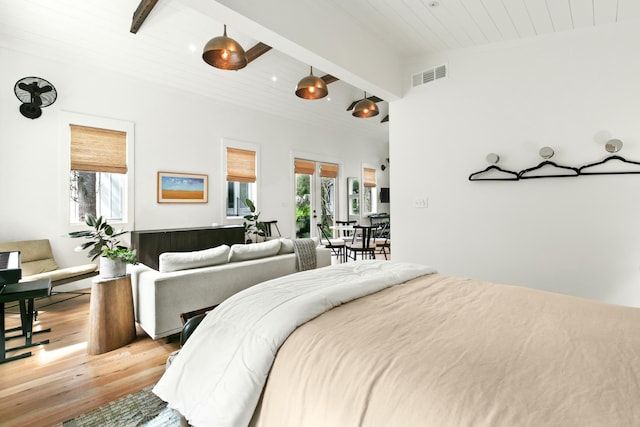 bedroom with wood ceiling, multiple windows, lofted ceiling with beams, and light wood-type flooring