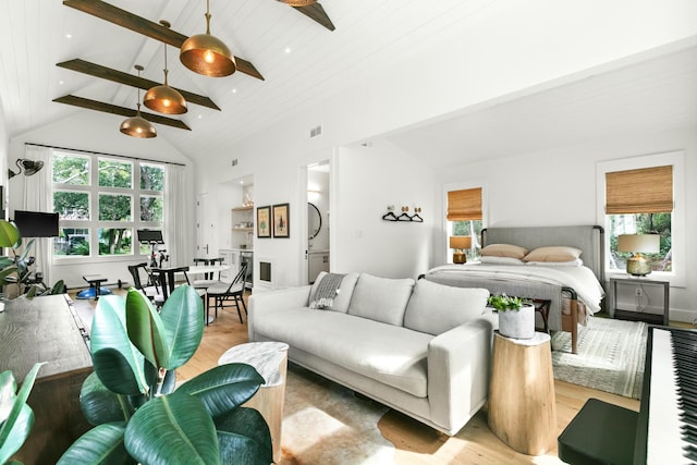 bedroom featuring light hardwood / wood-style flooring, beamed ceiling, wood ceiling, and high vaulted ceiling