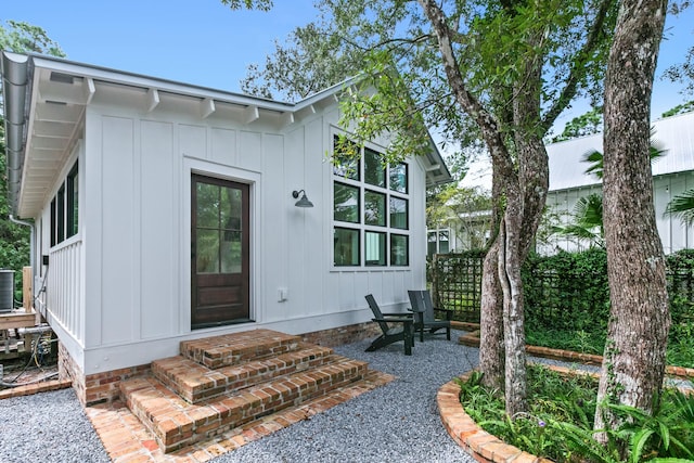 view of exterior entry with central AC unit