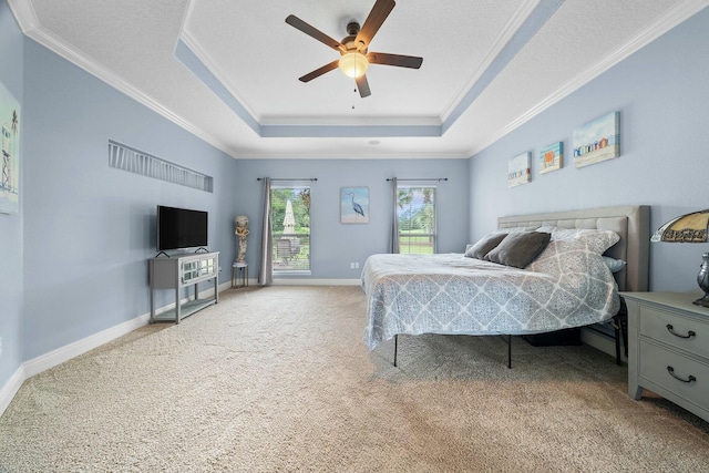 bedroom featuring carpet flooring, a tray ceiling, and ceiling fan