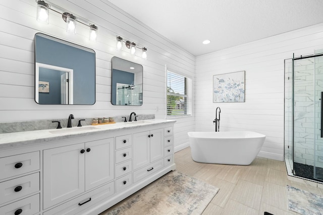 bathroom with plus walk in shower, vanity, and wood walls