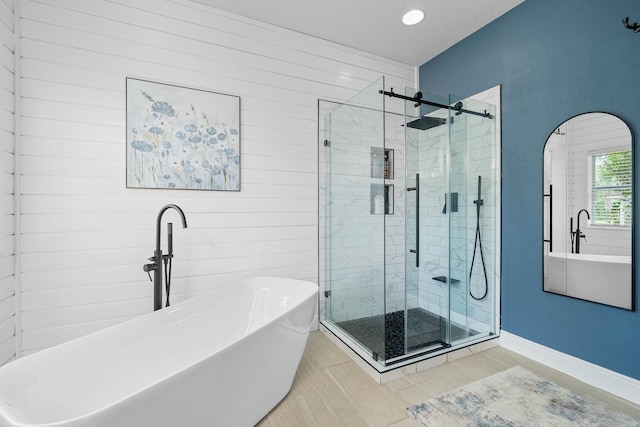 bathroom featuring tile patterned floors, wood walls, a textured ceiling, and plus walk in shower