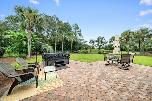 view of patio / terrace featuring a grill and a hot tub