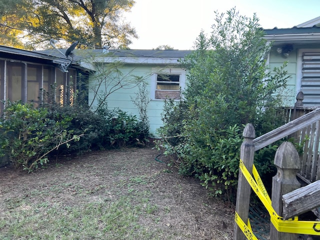 view of property exterior featuring a sunroom