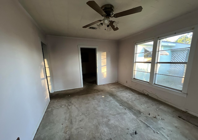 spare room featuring ceiling fan and ornamental molding