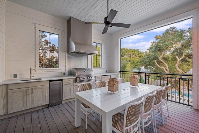 deck with a grill, area for grilling, ceiling fan, and sink