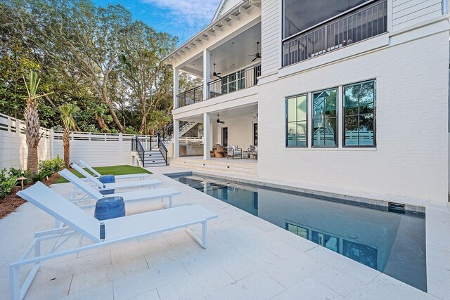 view of pool with a patio and ceiling fan