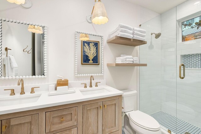 bathroom with vanity, toilet, and a shower with shower door