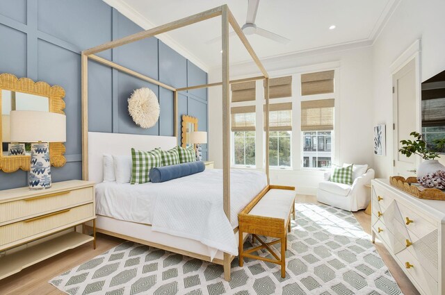 bedroom with wood-type flooring, ceiling fan, and crown molding