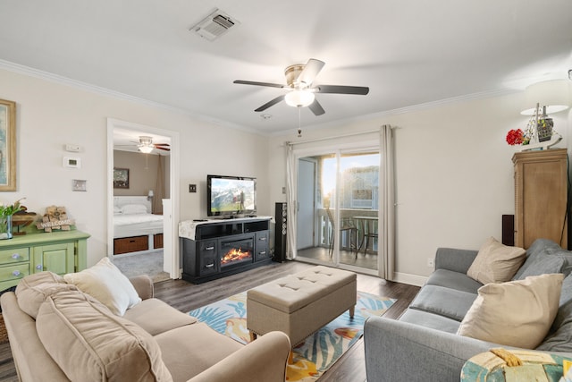 living room featuring a fireplace, dark hardwood / wood-style floors, and crown molding